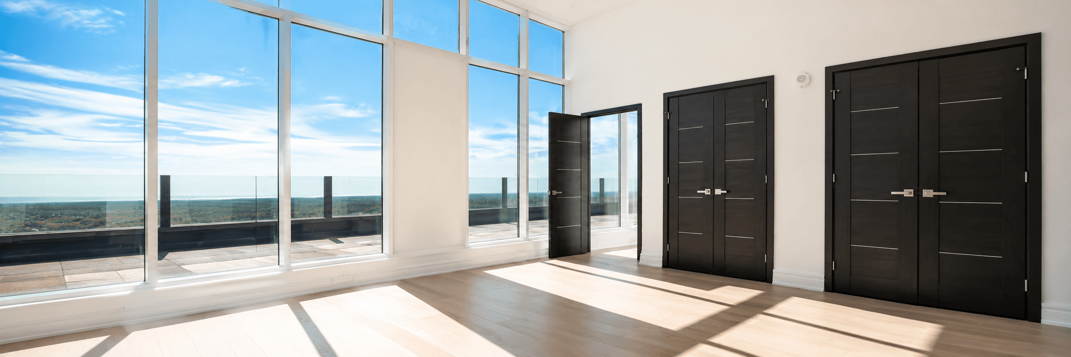 Penthouse room with black designer doors and floor-to-ceiling windows